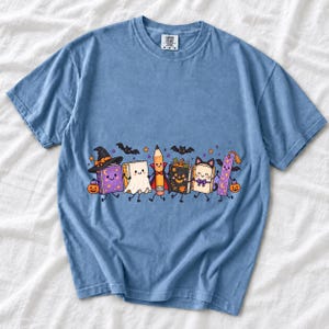 Kawaii books, pencil and bookmark with faces in Halloween costumes, pastel purple and orange