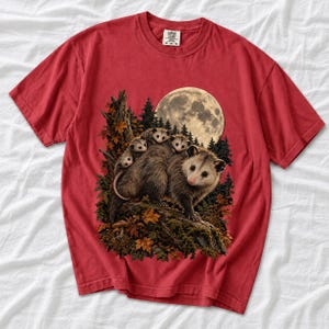 Mother opossum with babies on her back under a full moon and autumn leaves, dark realistic woodland illustration