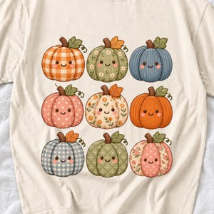 Grid of smiling pumpkins sewn from gingham, floral and corduroy patchwork fabric in autumn colors