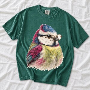Colored-pencil blue tit bird wearing tiny round reading glasses, funny birdwatcher t-shirt illustration