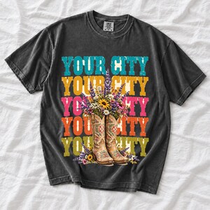 Tan cowboy boots with lavender and wildflowers over a five-line stacked personalized city word in retro colors