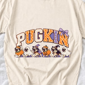 Six pugs in pumpkin, ghost and witch costumes under the arched word PUGKIN, lavender and orange polka-dot varsity style