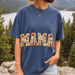 Arched varsity word MAMA filled with fall flowers and acorns in cream, rust and mustard