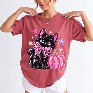 Puffy 3D black cat with a leopard bow beside a glossy pumpkin and stars in coquette style