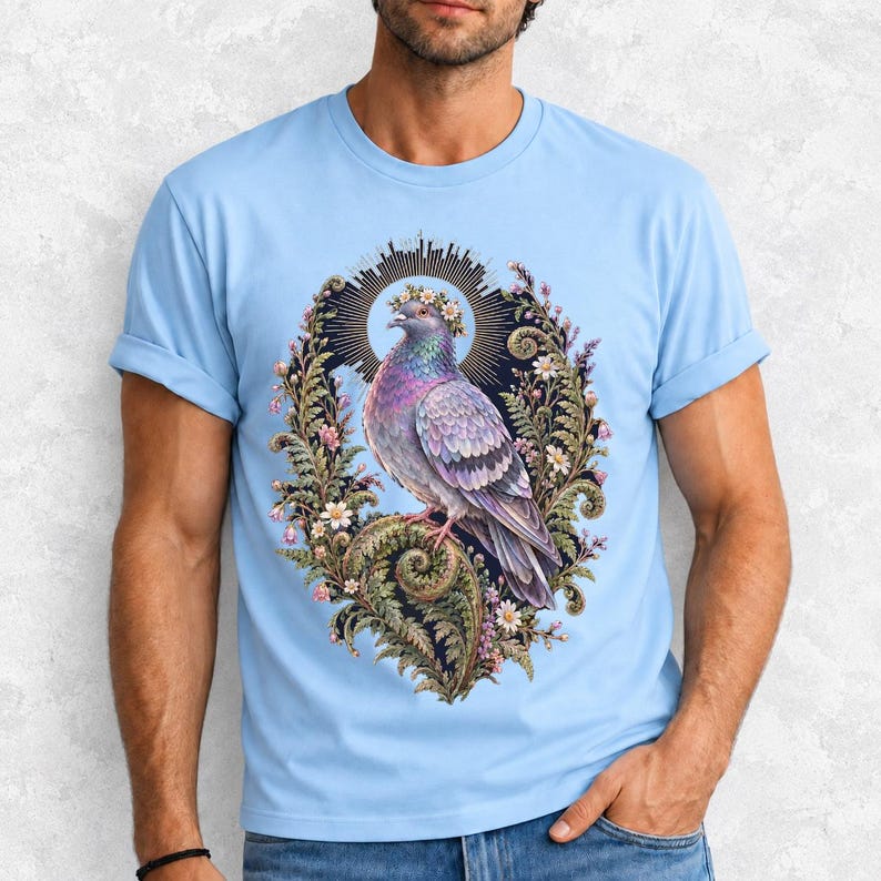 Painted pigeon wearing a daisy crown and glowing halo standing on a fern frond, whimsical cottagecore bird t-shirt art