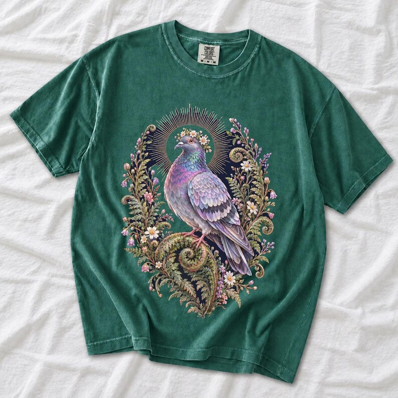 Painted pigeon wearing a daisy crown and glowing halo standing on a fern frond, whimsical cottagecore bird t-shirt art