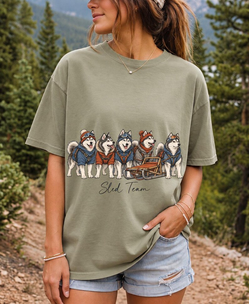 Illustrated huskies in ski gear lined up with a sled, text Sled Team