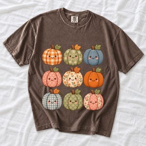 Grid of smiling pumpkins sewn from gingham, floral and corduroy patchwork fabric in autumn colors