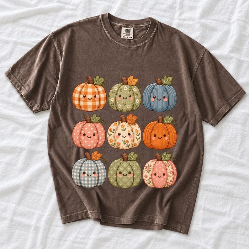 Grid of smiling pumpkins sewn from gingham, floral and corduroy patchwork fabric in autumn colors