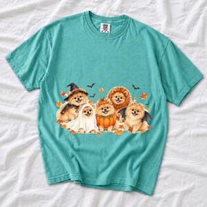 Five fluffy watercolor pomeranians in Halloween costumes with autumn leaves and bats