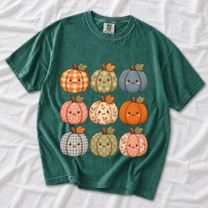 Grid of smiling pumpkins sewn from gingham, floral and corduroy patchwork fabric in autumn colors