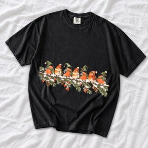 Watercolor bullfinches and robins in elf hats and scarves on a snowy pine branch