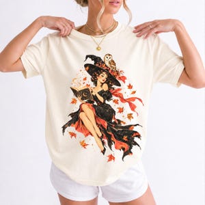 Retro 1950s pin-up witch floating while reading a spell book with an owl on her hat, autumn leaves