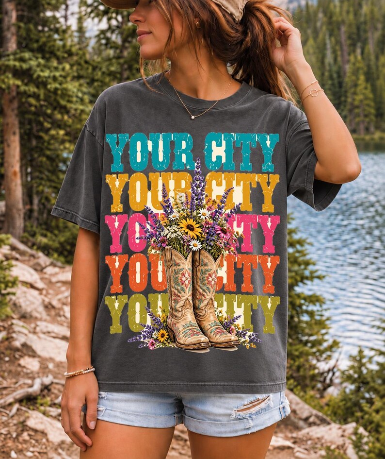 Tan cowboy boots with lavender and wildflowers over a five-line stacked personalized city word in retro colors