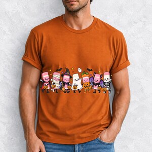 Seven cute erasers with faces in Halloween costumes holding candy buckets, flat crayon colors