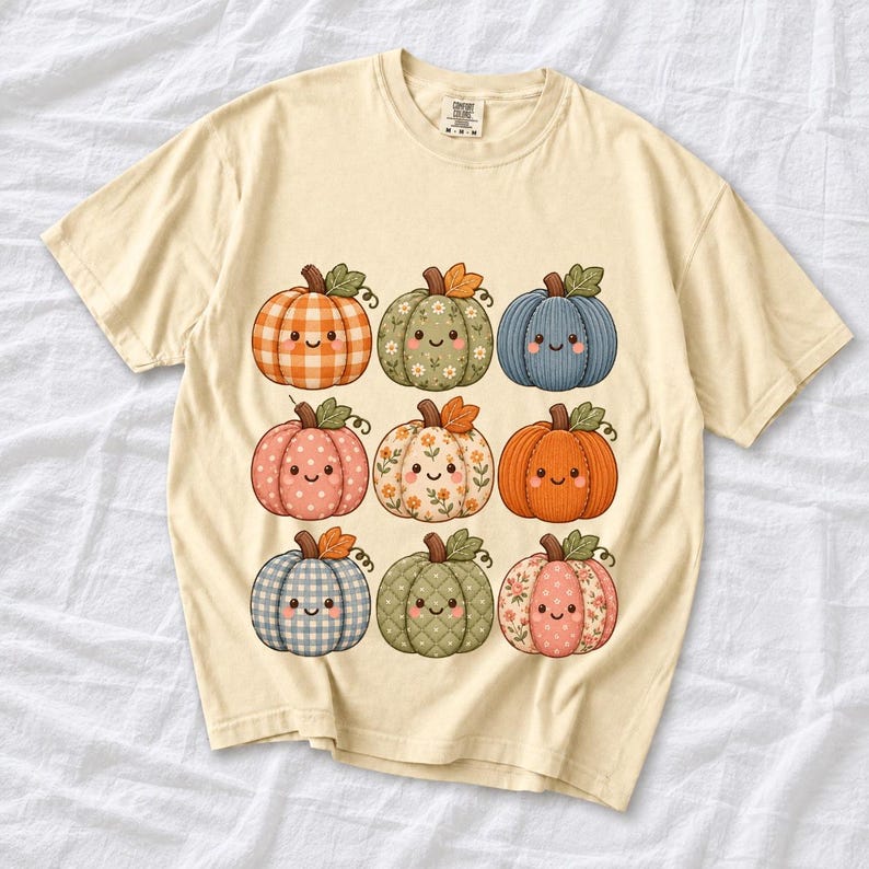 Grid of smiling pumpkins sewn from gingham, floral and corduroy patchwork fabric in autumn colors