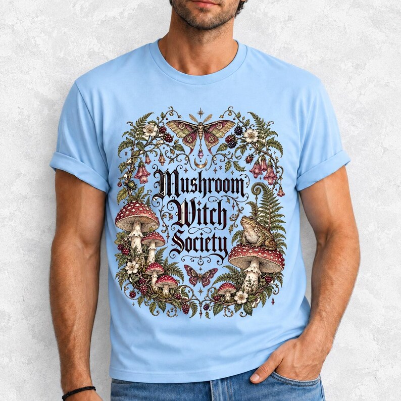 Blackletter text "Mushroom Witch Society" framed by fly agaric mushrooms, ferns and a toad on a mushroom cap