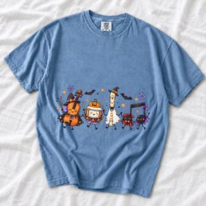 Kawaii violin, drum, recorder and notes with faces in Halloween costumes, pastel purple and orange