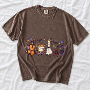 Kawaii violin, drum, recorder and notes with faces in Halloween costumes, pastel purple and orange