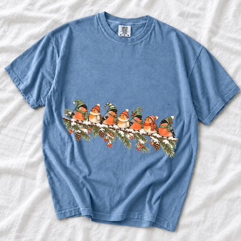 Watercolor bullfinches and robins in elf hats and scarves on a snowy pine branch