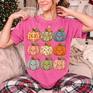 Grid of smiling pumpkins sewn from gingham, floral and corduroy patchwork fabric in autumn colors