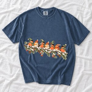 Watercolor bullfinches and robins in elf hats and scarves on a snowy pine branch