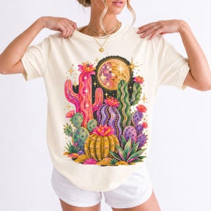 Retro 70s psychedelic glitter cacti with a disco ball moon in pink, mustard, violet and mint