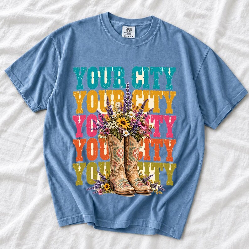 Tan cowboy boots with lavender and wildflowers over a five-line stacked personalized city word in retro colors