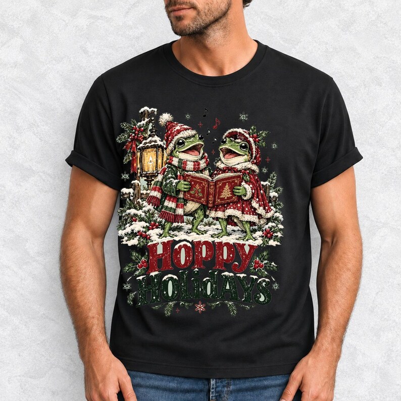 Two frogs singing carols in the snow with a lantern and songbook, text Hoppy Holidays