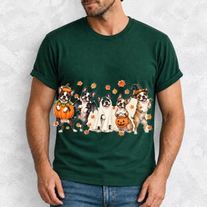 Five watercolor Boston terriers in Halloween costumes with falling autumn leaves