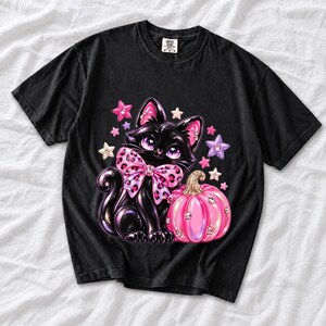Puffy 3D black cat with a leopard bow beside a glossy pumpkin and stars in coquette style