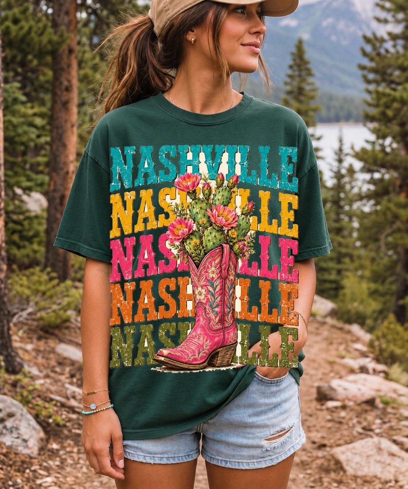 Pink embroidered cowboy boot with blooming cactus over a five-line stacked NASHVILLE word in retro colors