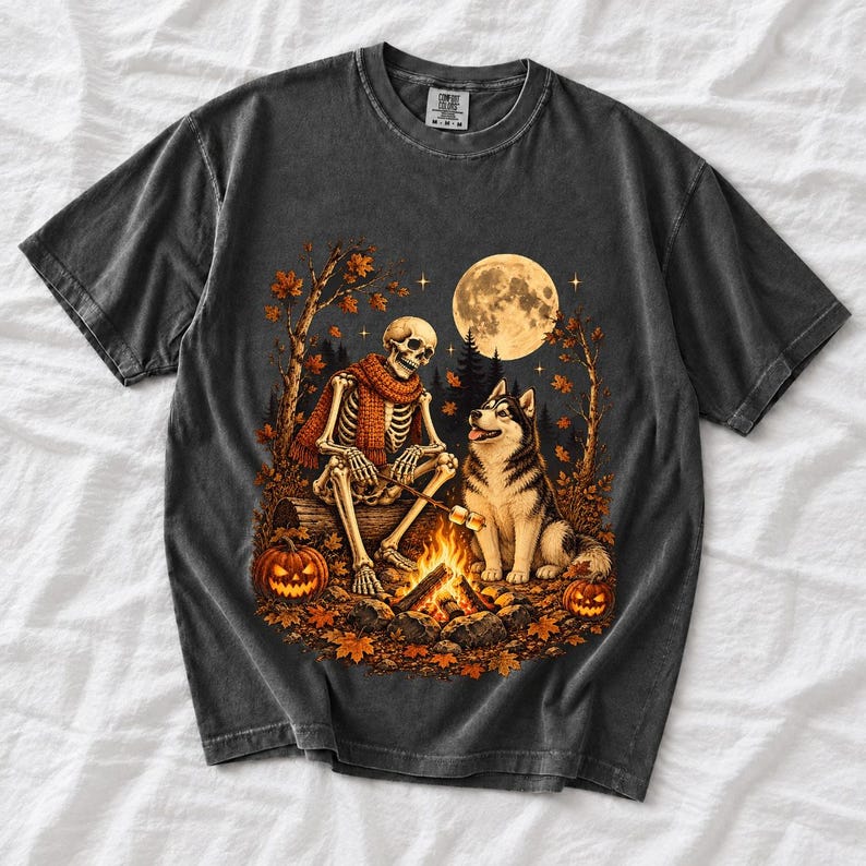 A skeleton in a scarf roasting marshmallows by a campfire beside a husky in an autumn forest under a full moon