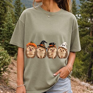 Realistic illustration of four hedgehogs wearing tiny Halloween hats in a row