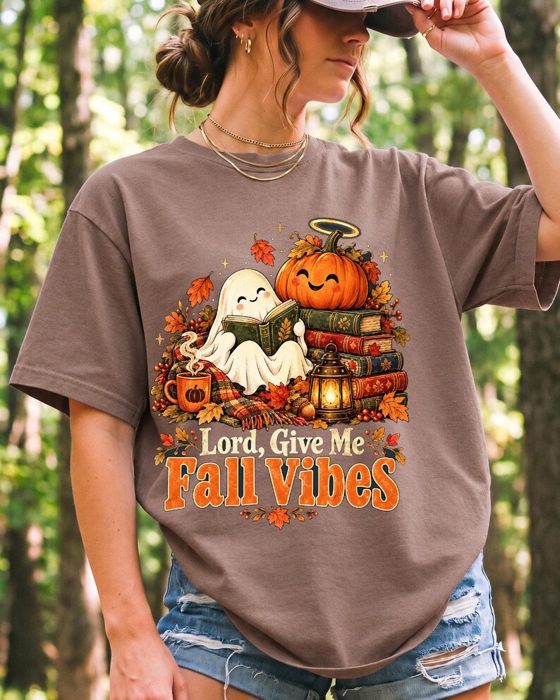 Smiling pumpkin with a halo beside a stack of books and a lantern, text "Lord, Give Me Fall Vibes", retro fall illustration