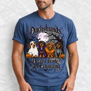 Four dachshunds in Halloween costumes under a spooky tree with text Dachshunds, Because People Are Exhausting