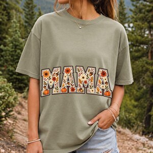 Arched varsity word MAMA filled with fall flowers and acorns in cream, rust and mustard