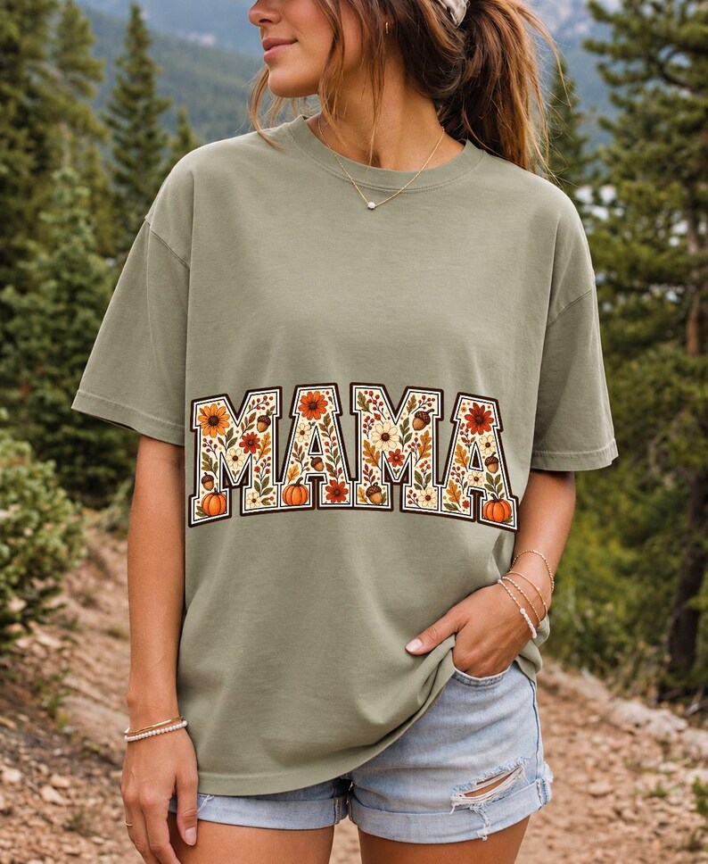 Arched varsity word MAMA filled with fall flowers and acorns in cream, rust and mustard