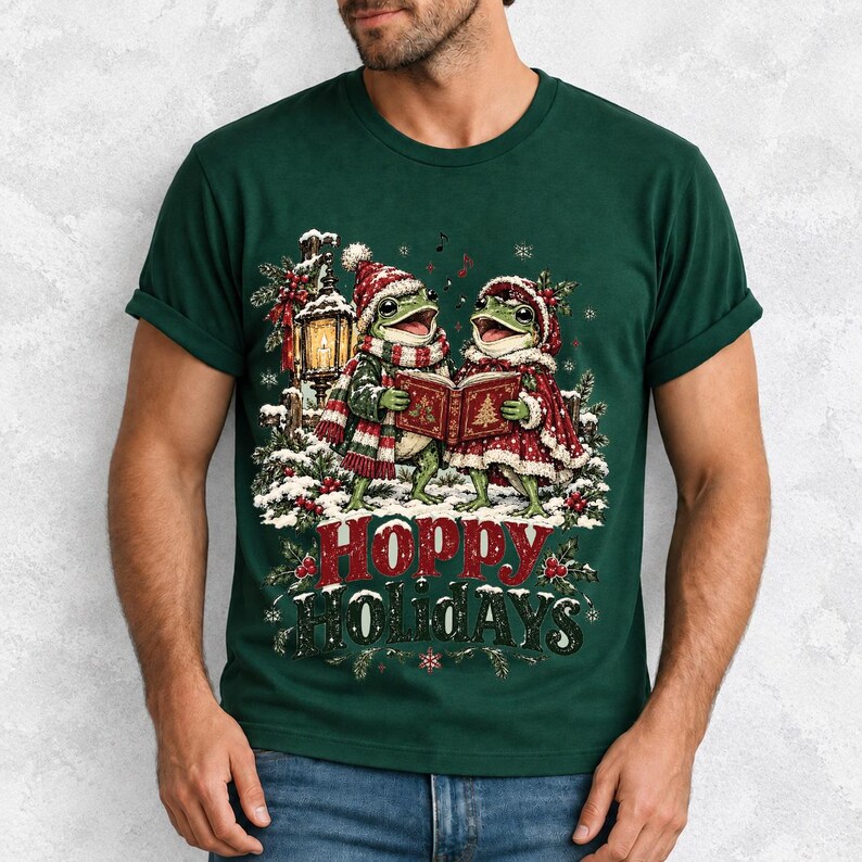 Two frogs singing carols in the snow with a lantern and songbook, text Hoppy Holidays