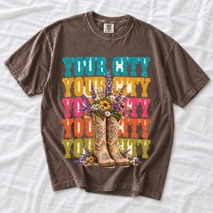 Tan cowboy boots with lavender and wildflowers over a five-line stacked personalized city word in retro colors