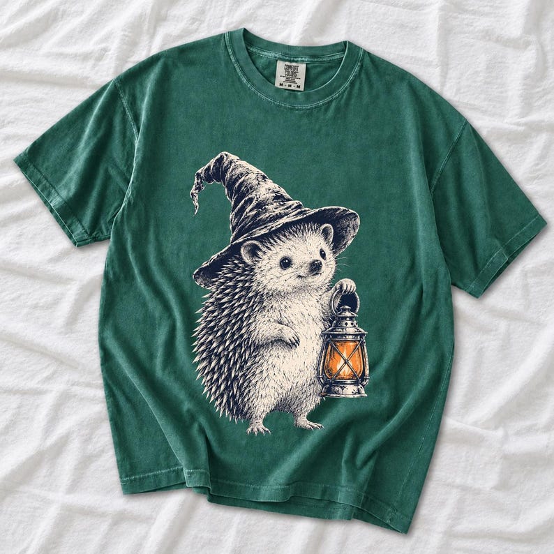 Etched pen illustration of a hedgehog in a witch hat holding a lantern, bone white with orange accent