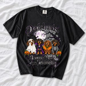 Four dachshunds in Halloween costumes under a spooky tree with text Dachshunds, Because People Are Exhausting