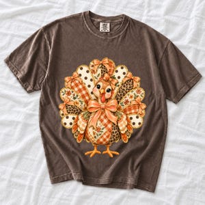 Turkey with patchwork fabric tail feathers decorated with bows on a cream and polka-dot stripe background