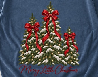 May include: A blue sweatshirt featuring a graphic of three green pine trees covered in snow and small yellow lights. Each tree is topped with a large red bow. The text "Merry Little Christmas" is printed in red script below the trees.