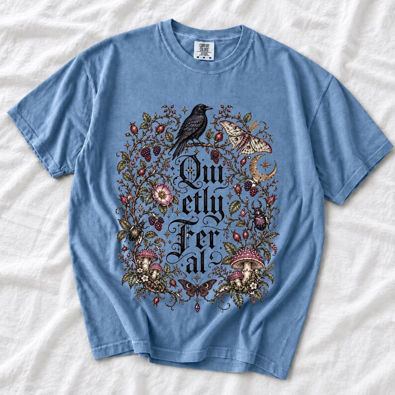 Raven on a wild rose branch with beetles and berries around blackletter text "Quietly Feral"