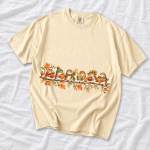 Row of watercolor sparrows on a branch holding tiny apples, corn and a pumpkin for harvest