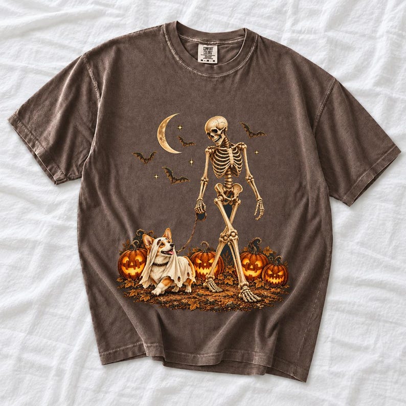 A skeleton walking a corgi in a ghost costume past carved pumpkins under a crescent moon