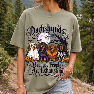 Four dachshunds in Halloween costumes under a spooky tree with text Dachshunds, Because People Are Exhausting