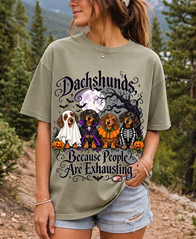 Four dachshunds in Halloween costumes under a spooky tree with text Dachshunds, Because People Are Exhausting