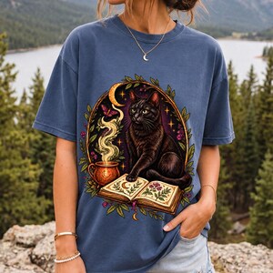 Black cat guarding an open botanical spellbook with a glowing potion cup